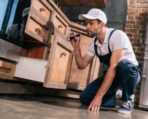 AdobeStock_213598887_Preview A man inspecting cabinets